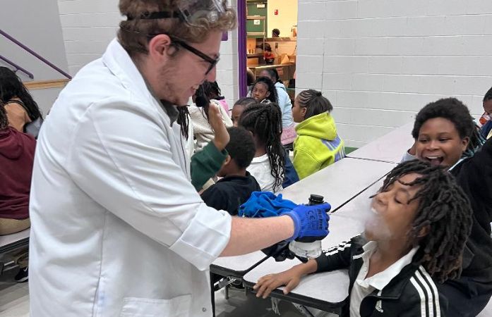  mad scientist spraying something in stidents mouth
